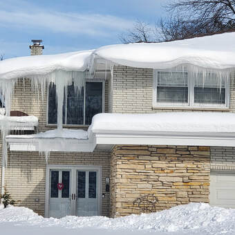 Ice Dam Icicles Build up on a Home in Grand Rapids Michigan