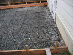 Picture of a concrete driveway in the process of being poored.